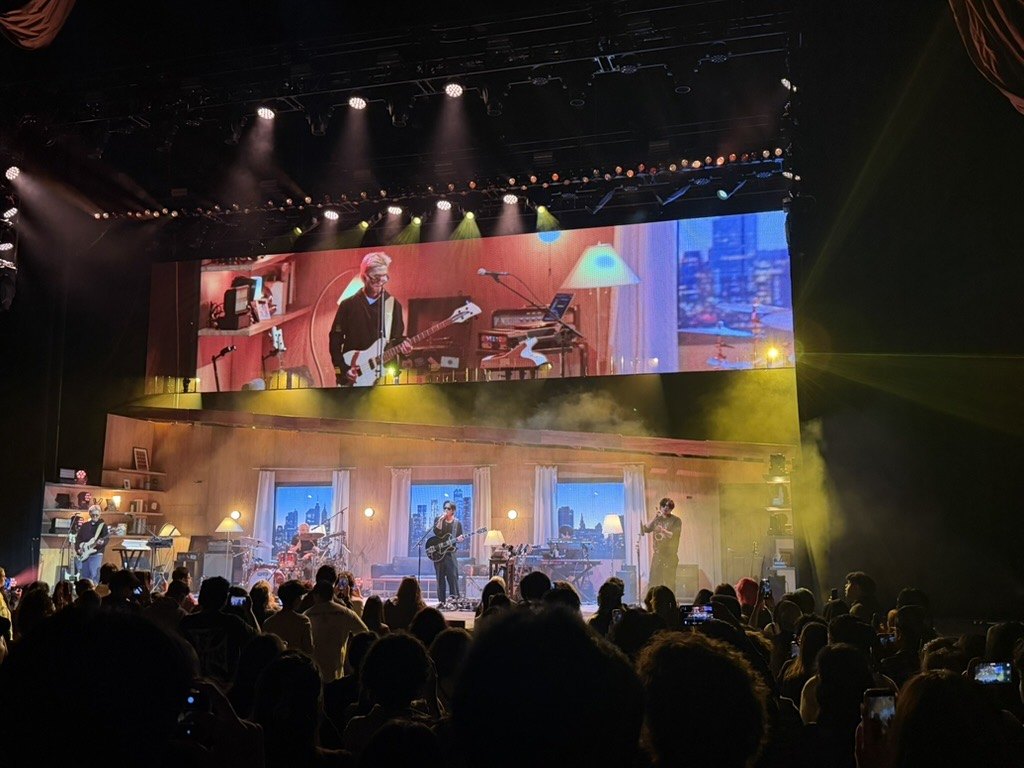 wave to earth on stage at Radio City Music Hall, September 29, 2026, under a wide video screen